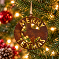 Merry Texmas rustic metal Christmas ornament by Rusty Decor featuring a Texas silhouette surrounded by plasma-cut Merry Texmas lettering. The 4.5-inch round ornament has an authentic natural rust patina and hangs from a 4-ply jute cord on a Christmas tree decorated with warm lights.